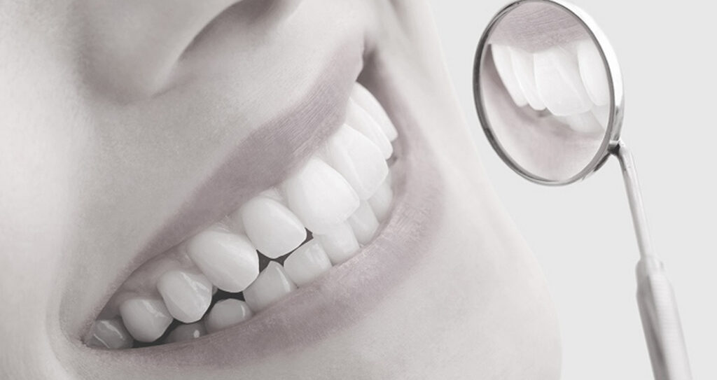 Closeup Of A Woman With A Dental Mirror