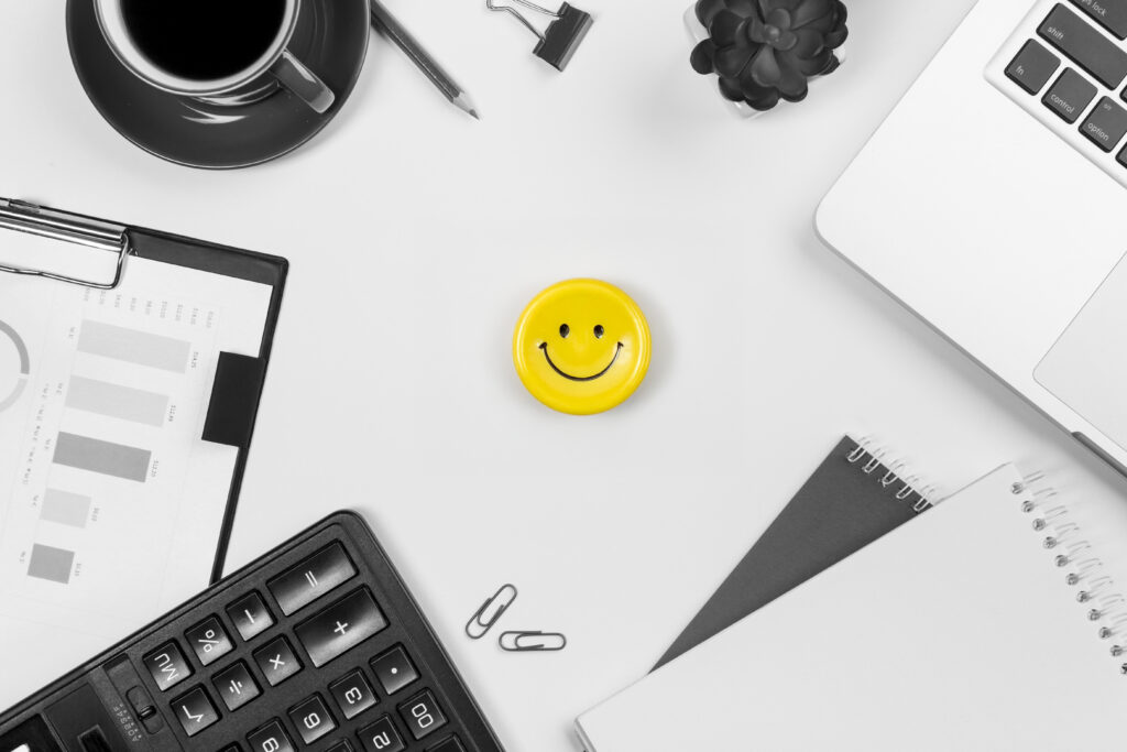 A Calculator Laptop Spiral Notepad Coffee Cup Cactus Plant White Desk