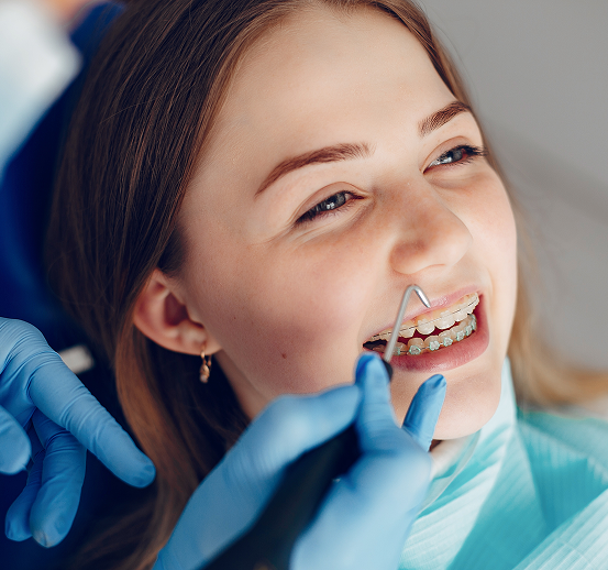 A Nurse With A Patient Girl With Braces