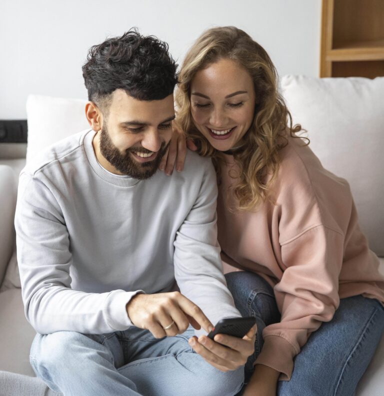Happy Couple At Home On The Phone