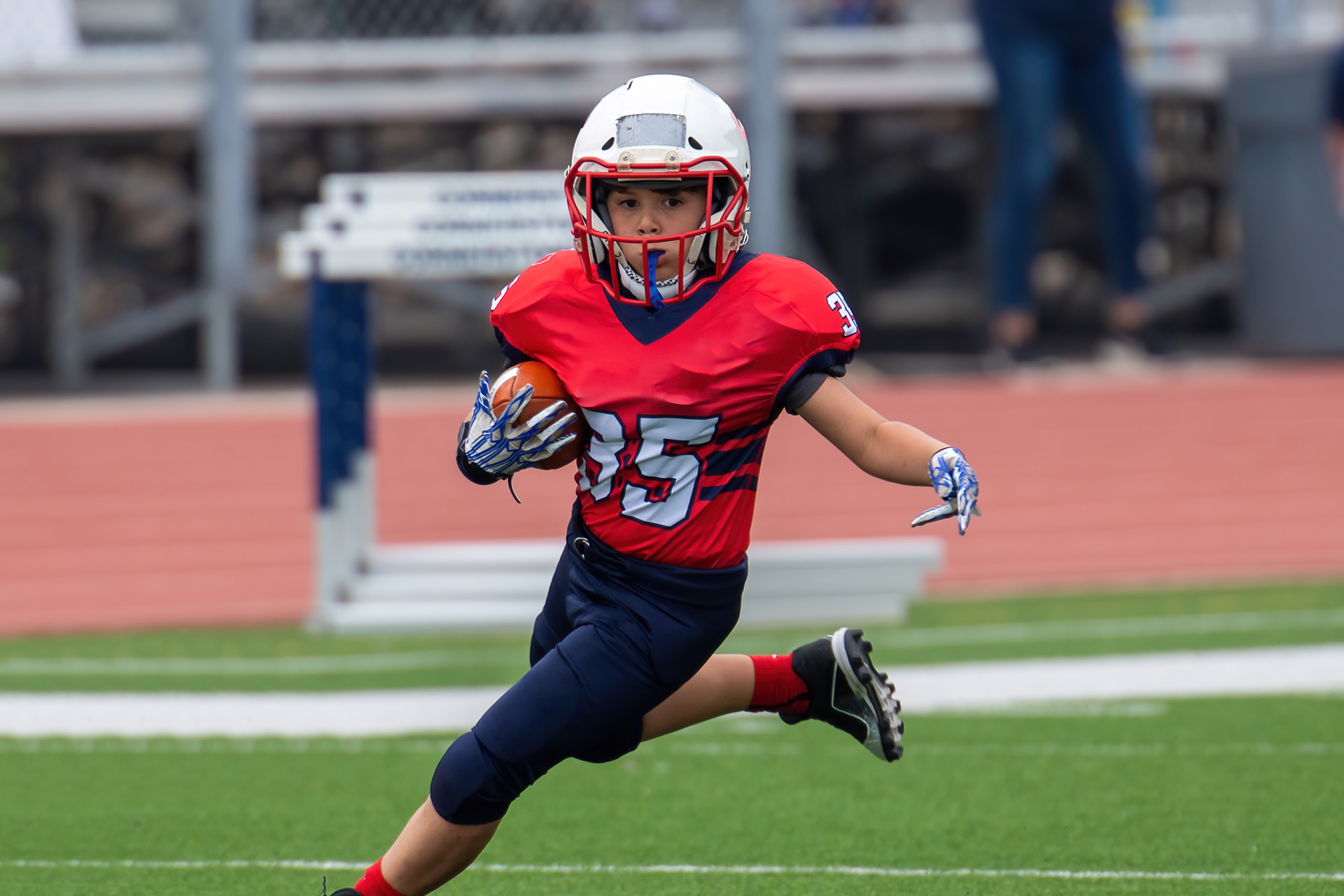 Athletic Young Boy Playing In A Football Game